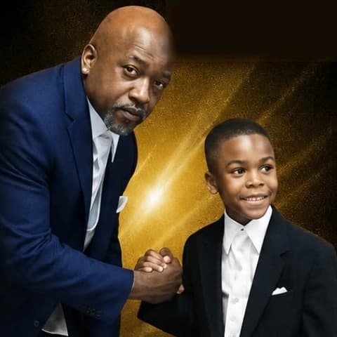 Kings of Purpose President Will Harris shaking hands with a Young King